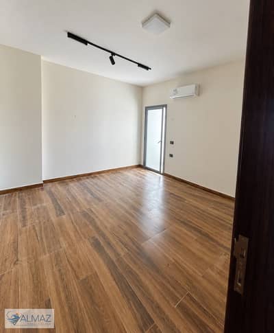 Unfurnished 165-square-meter apartment for rent, including a kitchen and air conditioning units, located in The Icon Residence compound in New Cairo