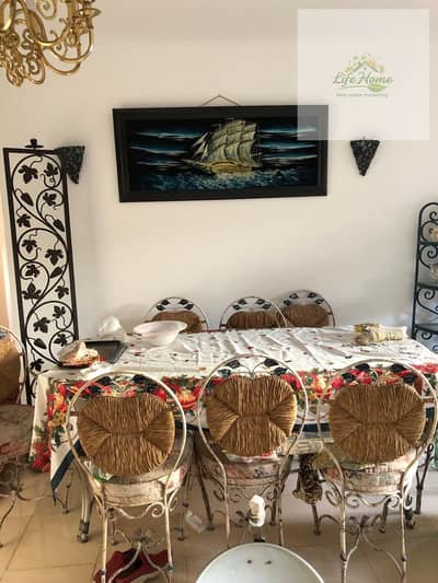 Furnished apartment for rent in Al-Rehab with three rooms, ground floor with garden, close to services