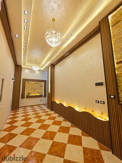 Ground floor apartment with a private entrance for sale in Al-Ajami, Palm Beach, next to the sea, super high-end finishing.