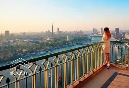 شقة للبيع باستثمار وعائد ثابت بالدولار علي كورنيش المعادي جاهزة بالفرش والمطبخ والتكييفات المركزيه بجوار هيلتون برج ريف دو نيل reve du nil