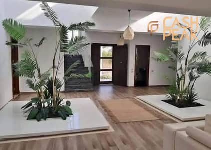 S-Villa with a 64% discount, fully finished in Talala Compound  New Heliopolis, right in front of Sodic East, featuring a lagoon and landscape view.