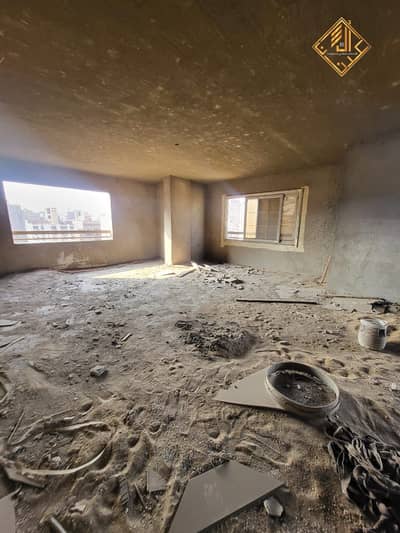 Apartment for sale (red-brick/shell condition) in a prime location in Mohandessin.