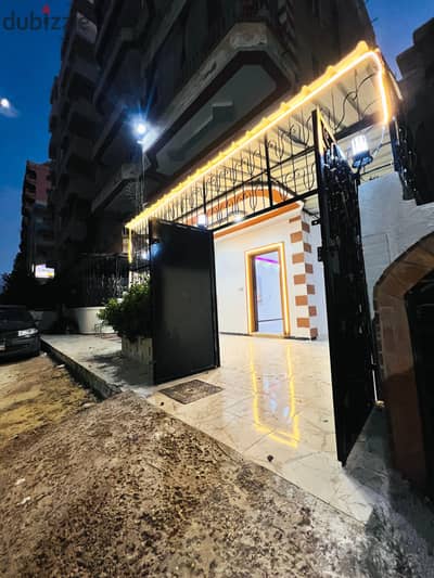 Ground apartment with a private entrance and a private garden in Al Ajami, Palm Beach, next to the main road and all services. Luxurious and distinctive finishing suitable for investment and permanent residence, registered and complete with attachments.