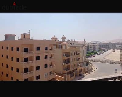 Apartment for sale 240m in Kanaria Compound – Sheikh Zayed | July 26 Axis - with a front view of the main street.