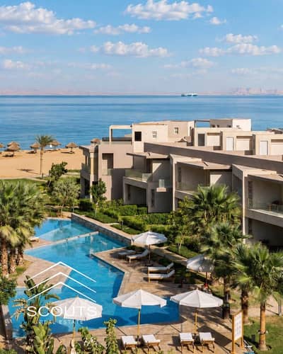 Available for sale: a 96 sqm, two-bedroom chalet in the BOHO resort, Ain Sokhna. The unit features a dual view—overlooking both the lagoon and the sea