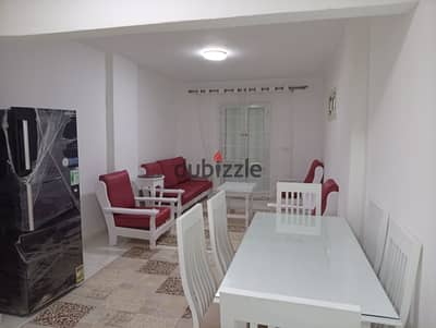 Furnished apartment for annual rent for families, couples, students, or companies. 3 bedrooms, two-piece reception, kitchen, bathroom, on the third floor, very comfortable staircase in Alexandria, Al-Ajami, kilo 21, the first main October Street in a very distinguished location.