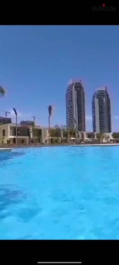 Repeated floor, fully finished, Lagoon view, immediate handover, full panorama of Alamein Towers, chalet for sale at Palm Hills Alamein New Resort, No