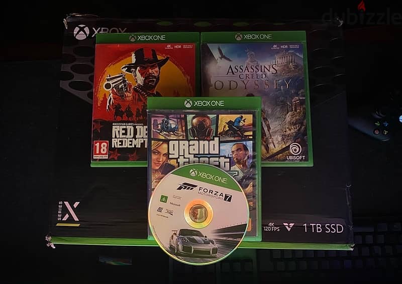 Xbox cd (GTAV - Red Dead 2 - Ac odyssey - Motorsport 7)+Dobe Batteries 1