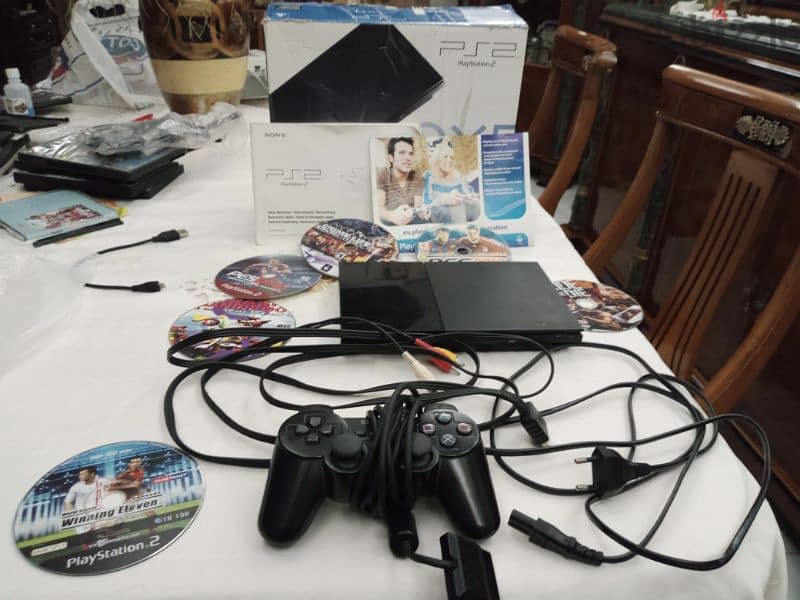 for sale Playstation 2 slim as new with original controller + another 1