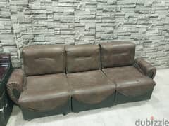 brown sofa with 2 black chairs 0