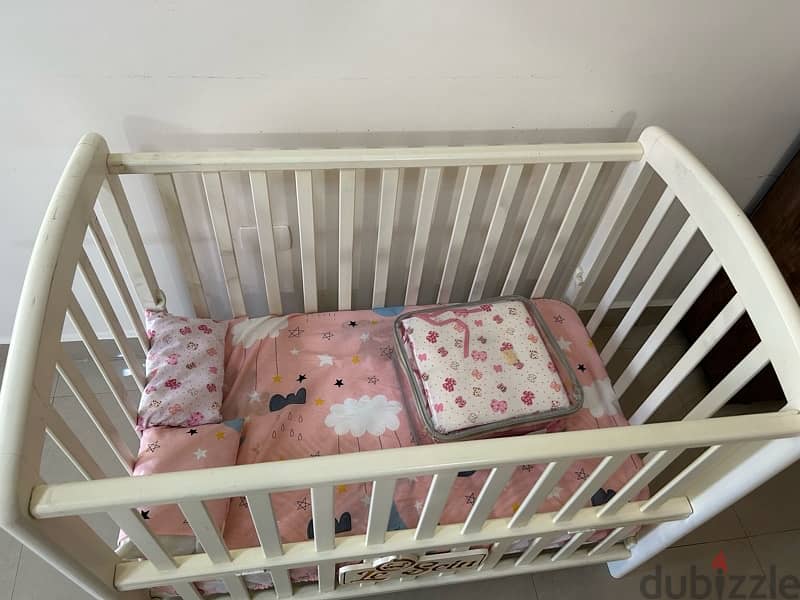 adjustable baby crib ( slightly used) 1