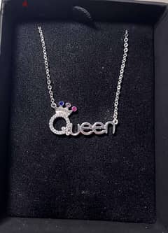 a necklace of zircon stones with the word Queen silver