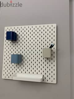 Ikea pegboard with 3 cup stoarges and a shelf