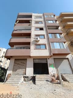 A commercial store for rent in the investment buildings, Al-Firdous City 0