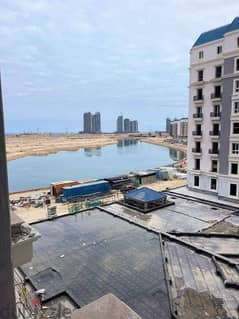Fully finished apartment with lagoon view, immediate receipt, for sale in the Latin District, New Alamein, North Coast, in installments over 7 years