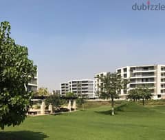 For sale, an apartment with a 133 sqm panoramic view on the largest green area inside the compound in Origami Taj City, directly on the Suez Road.