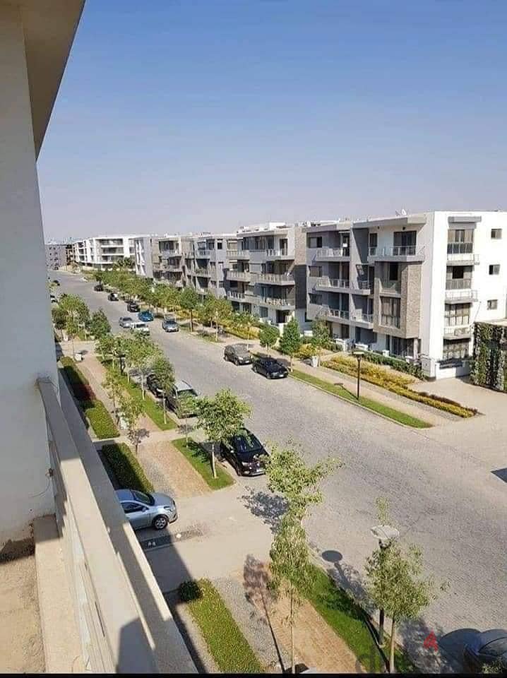 For sale, an apartment with a 133 sqm panoramic view on the largest green area inside the compound in Origami Taj City, directly on the Suez Road. 9