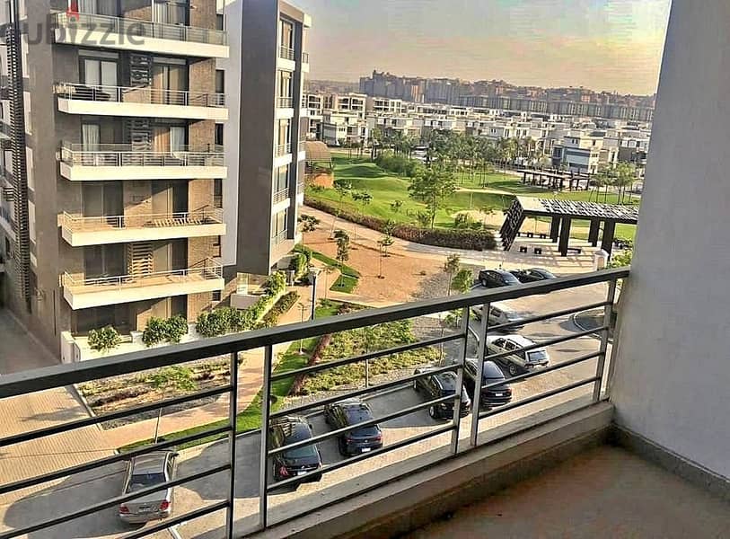 For sale, an apartment with a 133 sqm panoramic view on the largest green area inside the compound in Origami Taj City, directly on the Suez Road. 10
